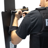 Side of man holding black 15" x 25" Caliber Armor Pistol rated Level IIIA HG2 Ballistic Shield with pivoting handle on a white background