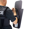 Backside view of man holding black 15" x 25" Caliber Armor Pistol rated Level IIIA HG2 Ballistic Shield with pivoting handle for left handed shooter on a white background