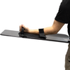 Person holding a black bullet proof shield with thier arm through the velcro retention strap & grabbing the wrapped handle on a white background