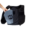 Black tactical vest with a gray armor plate being side loaded into the front of the vest