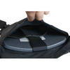 Close-up of a black carrier with hard armor plate pocket, shown with plate inserted into carrier and held in place with velcro retension strap