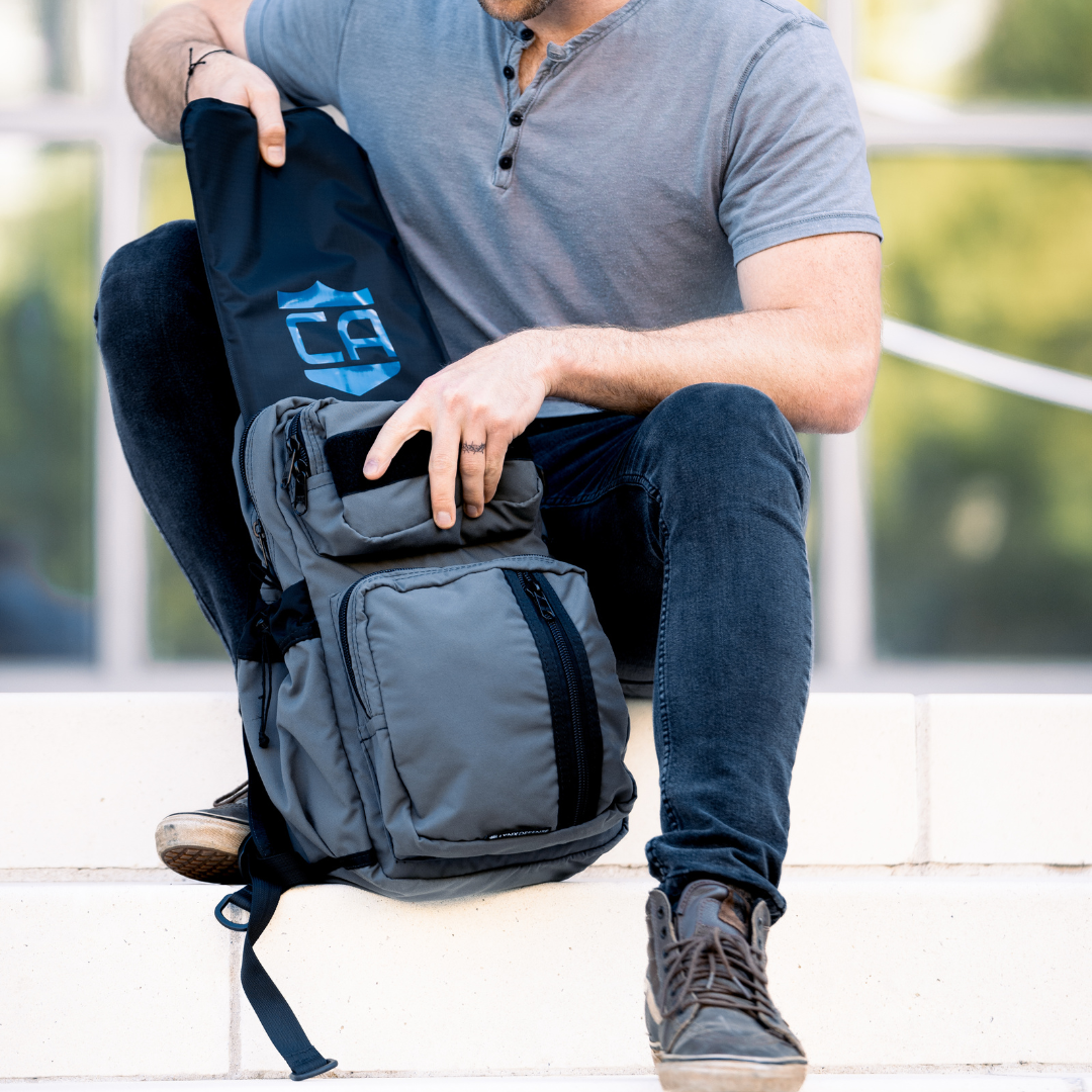 man putting soft body armor into a lynx defense backpack for everyday armored protection