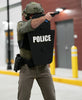 Police officer holding black 15" x 25" Caliber Armor Ballistic Shield