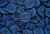 a pile of pvc patch with velcro backing that is the Caliber Armor logo in blue with the background being black