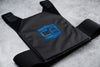 Black gray man carrier provides discreet protection with low profile soft armor laying flat on ground