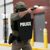 Police officer holding black 15" x 25" Caliber Armor Ballistic Shield