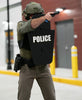Police officer holding black 15" x 25" Caliber Armor Ballistic Shield